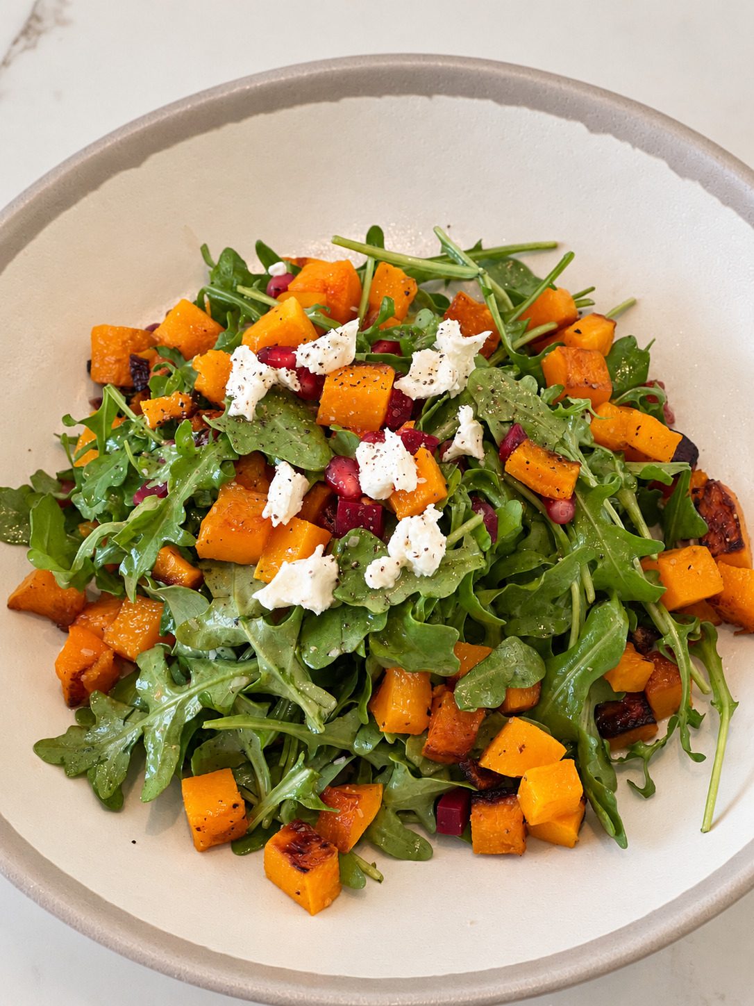 Roasted butternut squash and arugula salad with goat cheese and pomegranate